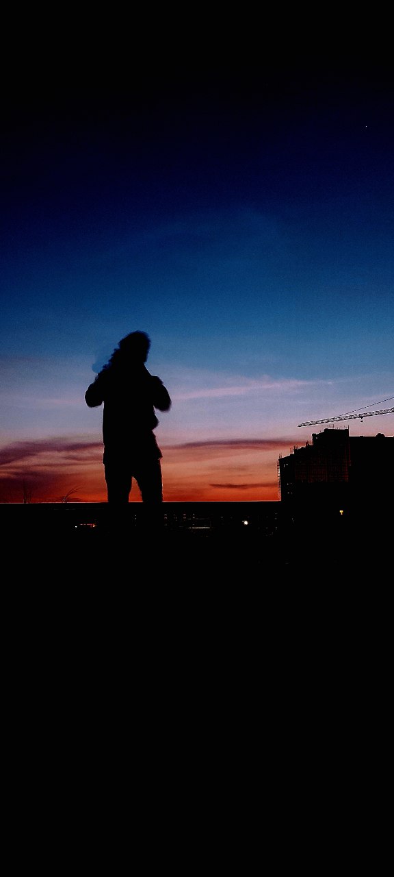 a silhouette of a man at night